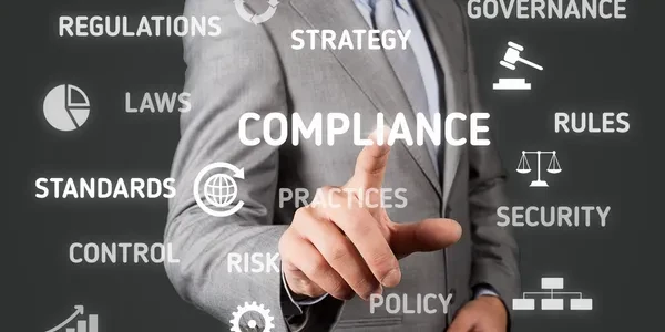 Business professional reviewing compliance, regulations, and security requirements